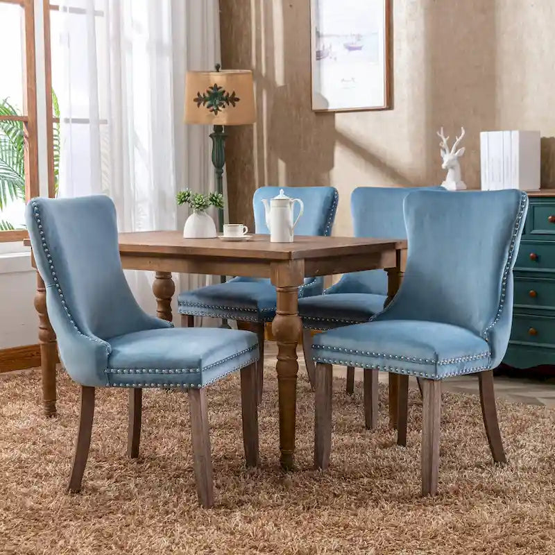 Chaise de salle à manger à oreilles en velours avec clous décoratifs et surpiqûres en losange bleues