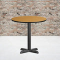 Table de salle à manger ronde en stratifié avec piétement en croix en fonte naturelle